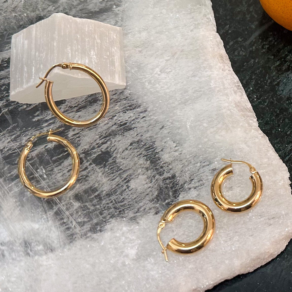 this image show different sides gold hoop earrings and sterling silver Gucci chain and bracelet