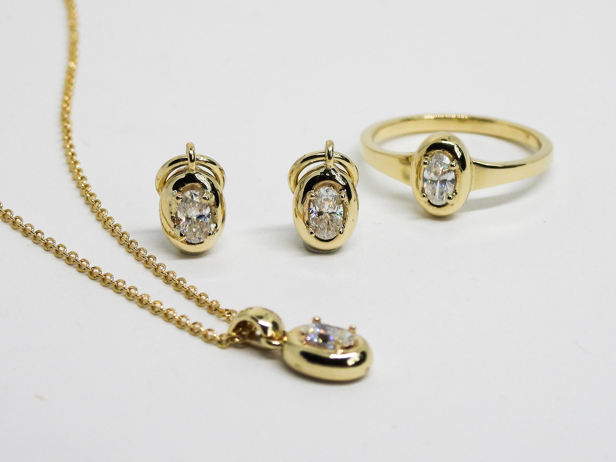 gold necklace, ring and hoop earrings charms