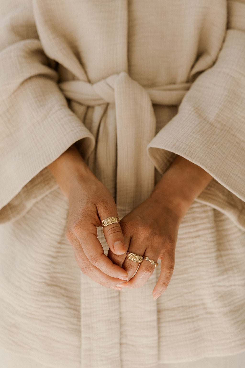 model wears layers of gold rings. gold rings in Cape Town south africa 