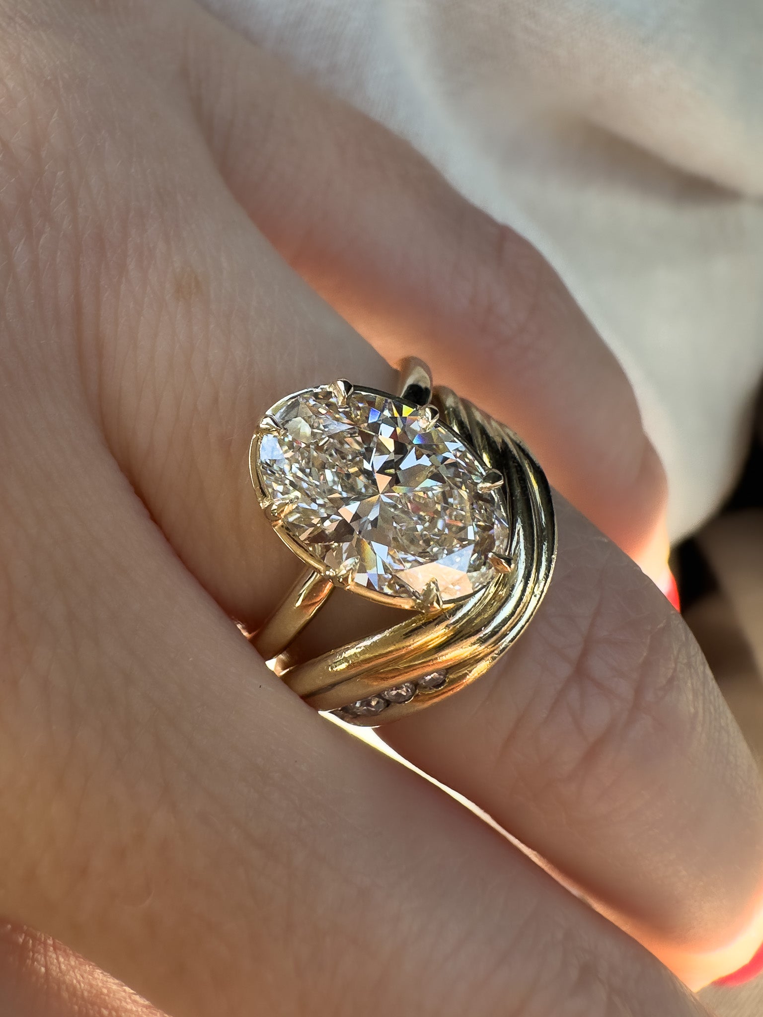 Gold ring with a large diamond on a finger
