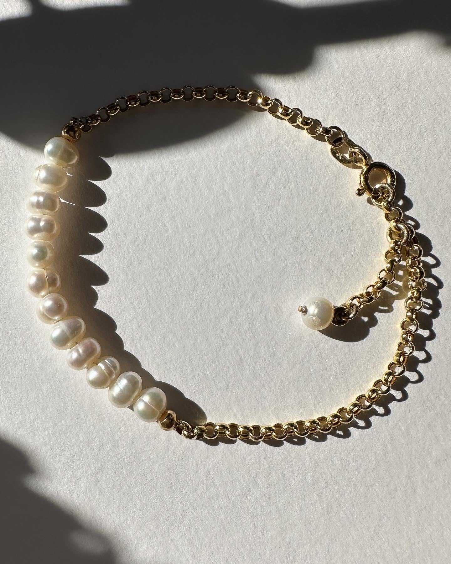 gold bracelet strung with natural pearls.