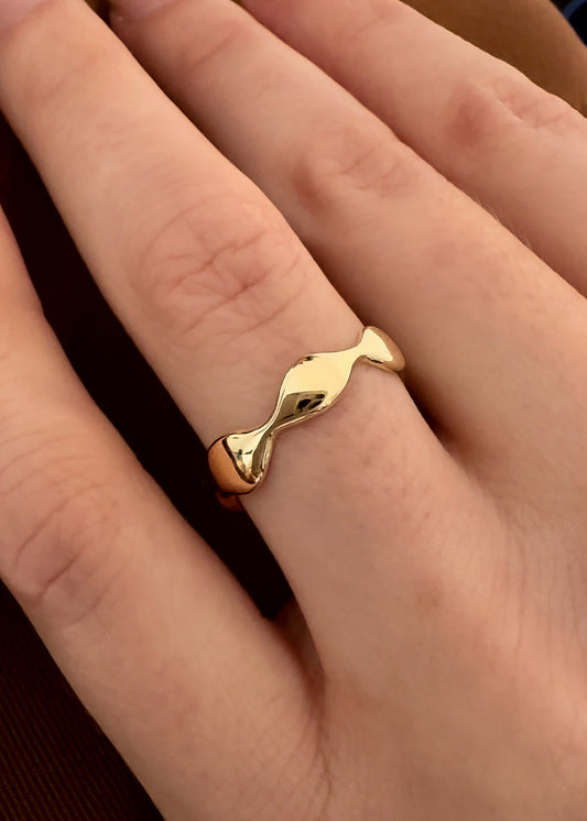 Distinctive Design: The flat band is adorned with playful ripple and squiggle details, adding an element of charm and uniqueness to your ensemble. Precious Metal: Crafted from solid 9ct yellow gold, this ring exudes warmth and timeless elegance.