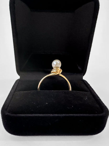 The ring features a single 4mm freshwater pearl, set high to capture and showcase its innate beauty. Precious Metal: Crafted from enduring 9ct or 18ct yellow gold, this ring not only enhances the pearl's charm but also ensures a lasting place in your cherished jewellery collection. Pearl ring.
