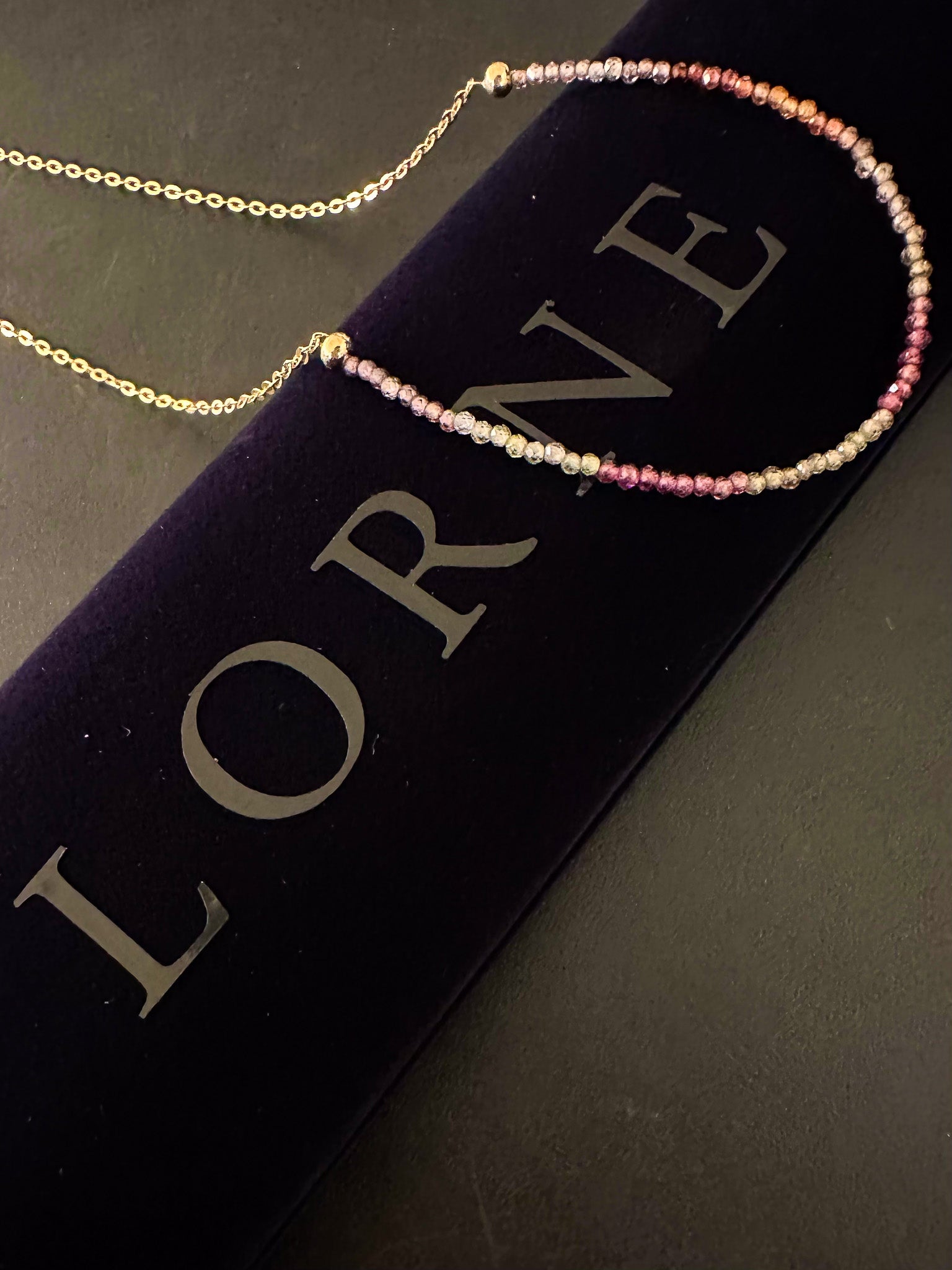 LORNE Natural Multi-Colour Sapphire Bead Necklace—a stunning and eye catching piece of jewellery that combines the allure of sapphire beads with the elegance of a 9ct yellow gold anchor chain.