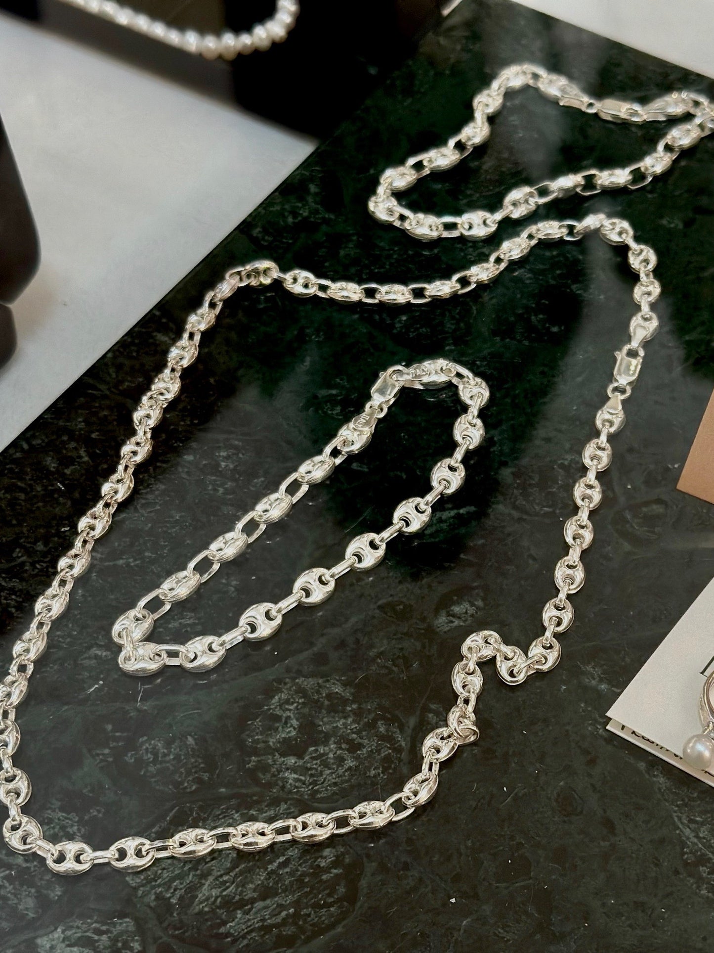 jewellery displayed beautiful for a jewellery store, featuring a sterling silver Gucci necklace and Gucci link bracelets.