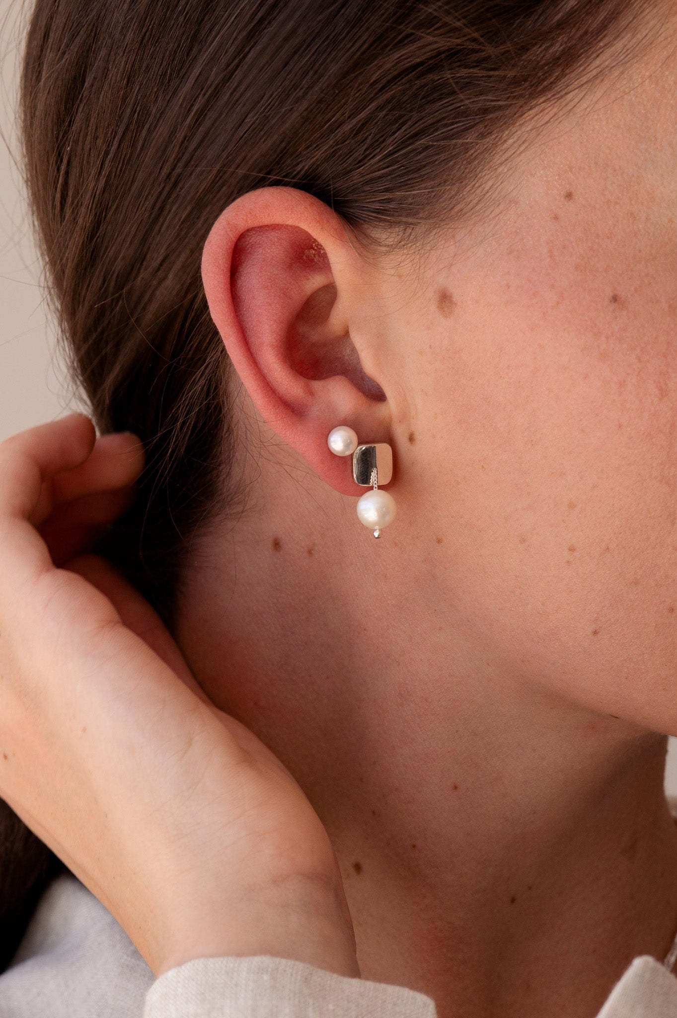 model wears pearl earrings