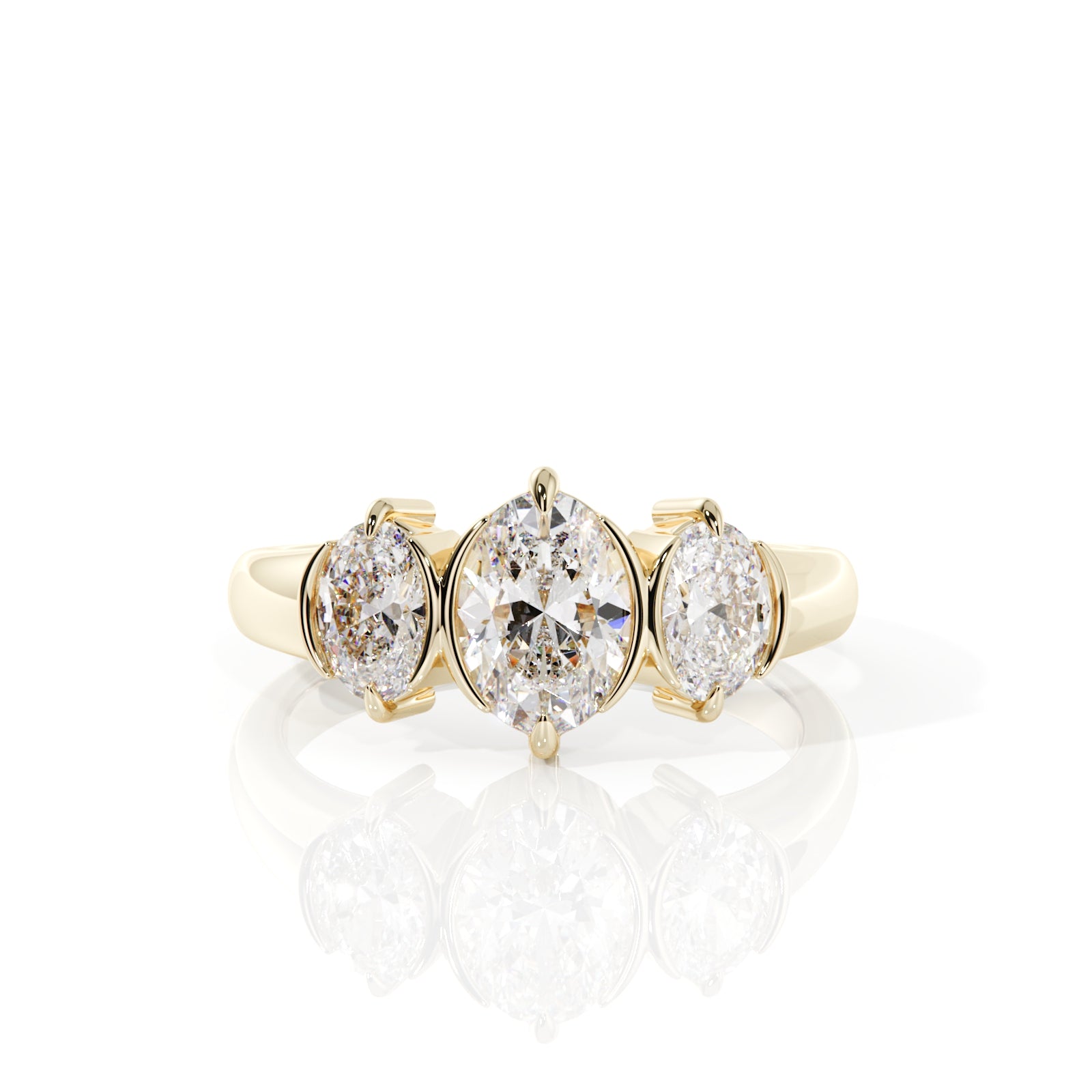 A yellow gold three-stone ring featuring a large oval center diamond flanked by two smaller round diamonds, set against a clean white background with a soft reflection below.