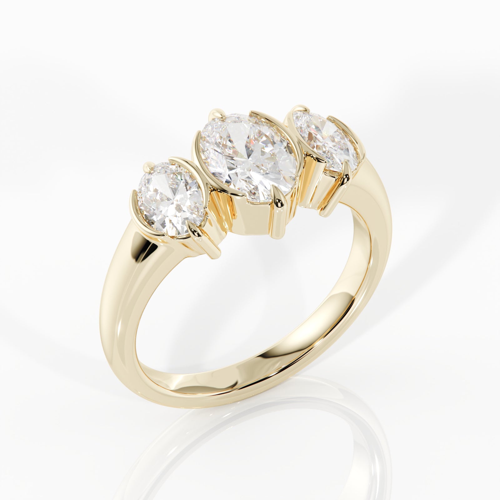 A yellow gold three-stone ring featuring round brilliant-cut diamonds in a prong setting, displayed on a clean white background with a soft reflection.