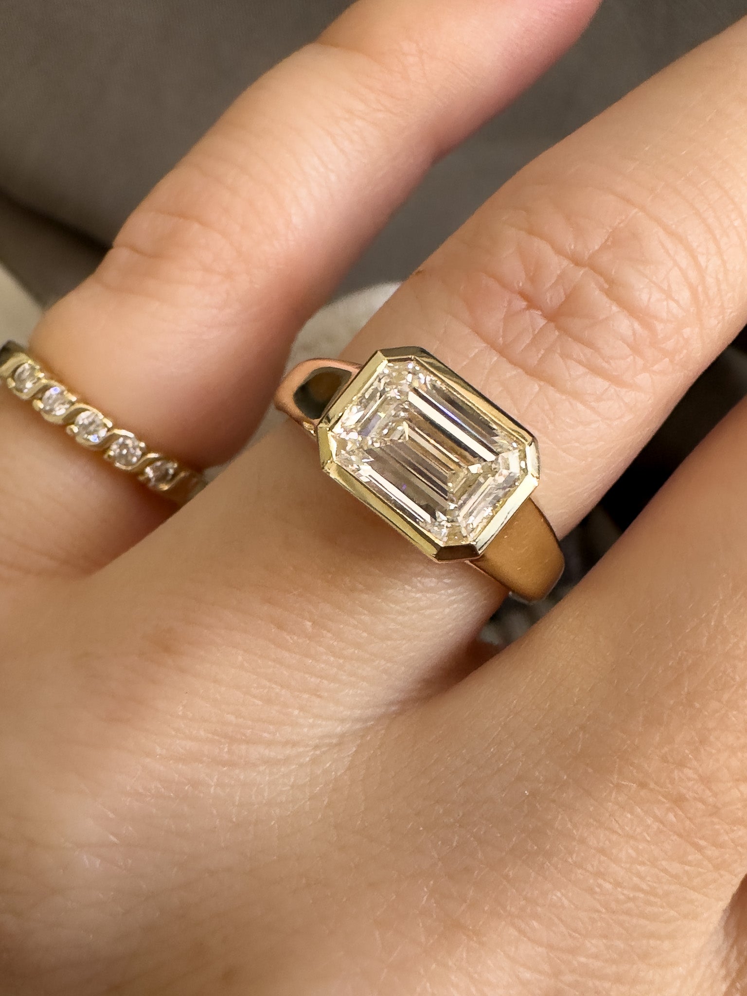 Gold ring with a large diamond on a finger
