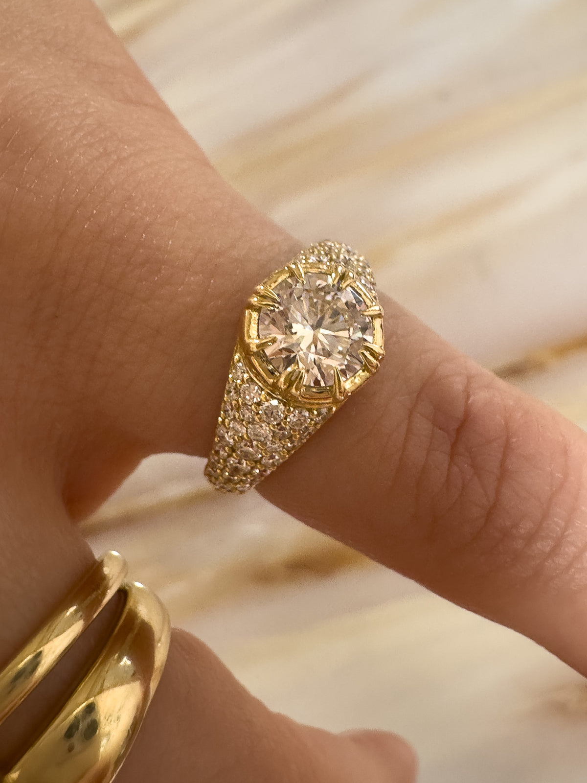 pavé diamond ring. round centre diamond in claw setting. Cape Town jewellery. gold ring worn on pinky finger. 