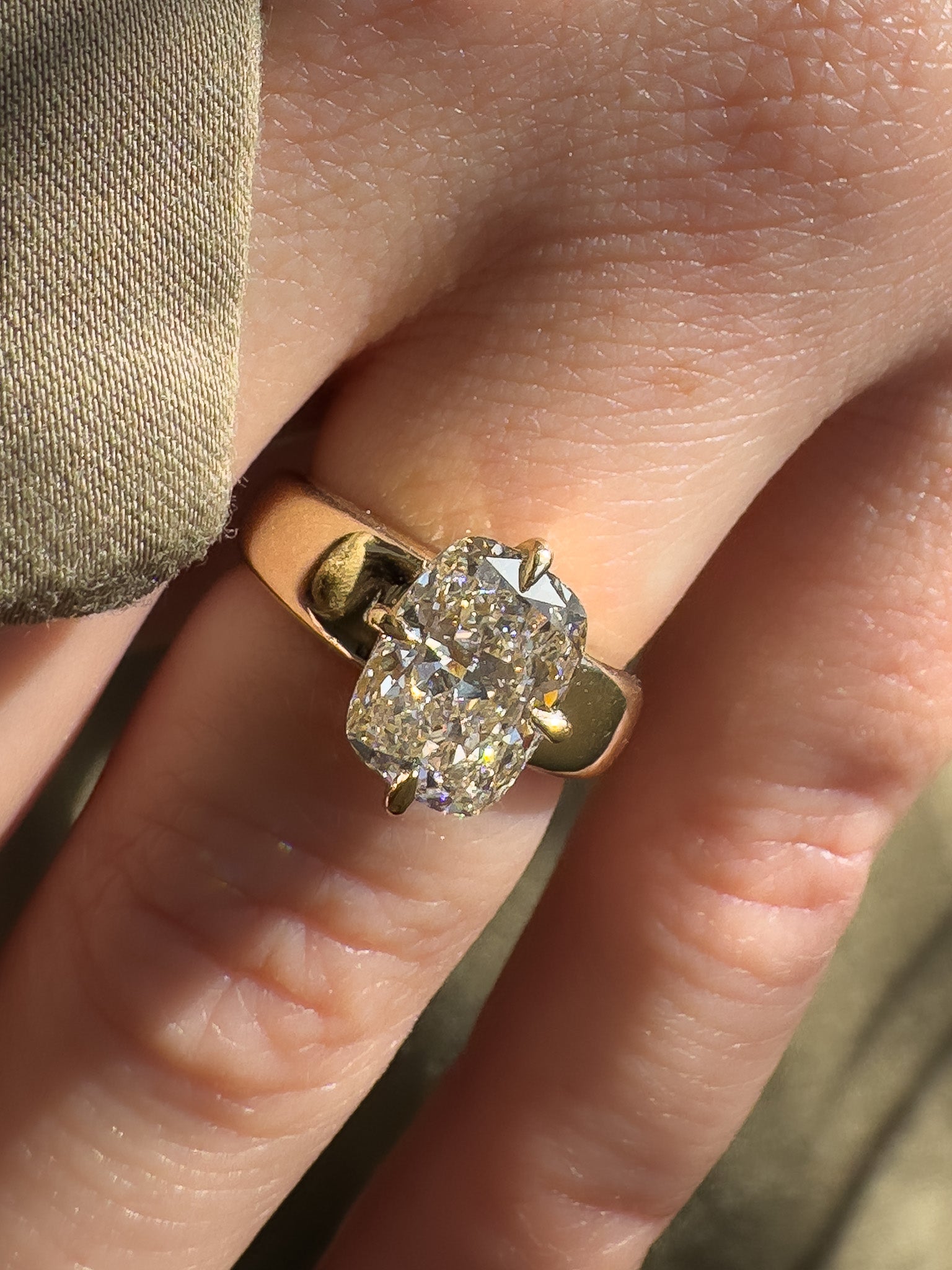 Gold ring with a diamond on a finger