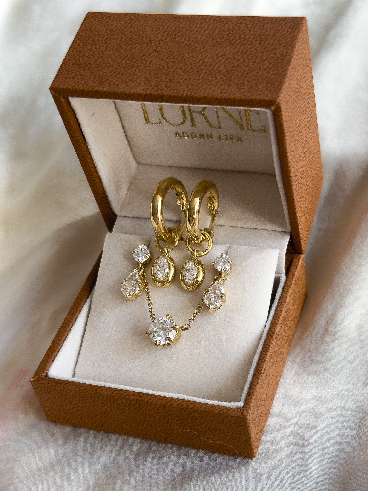 Gold jewelry set with diamonds in a LORNE JEWELLERY box on a white background