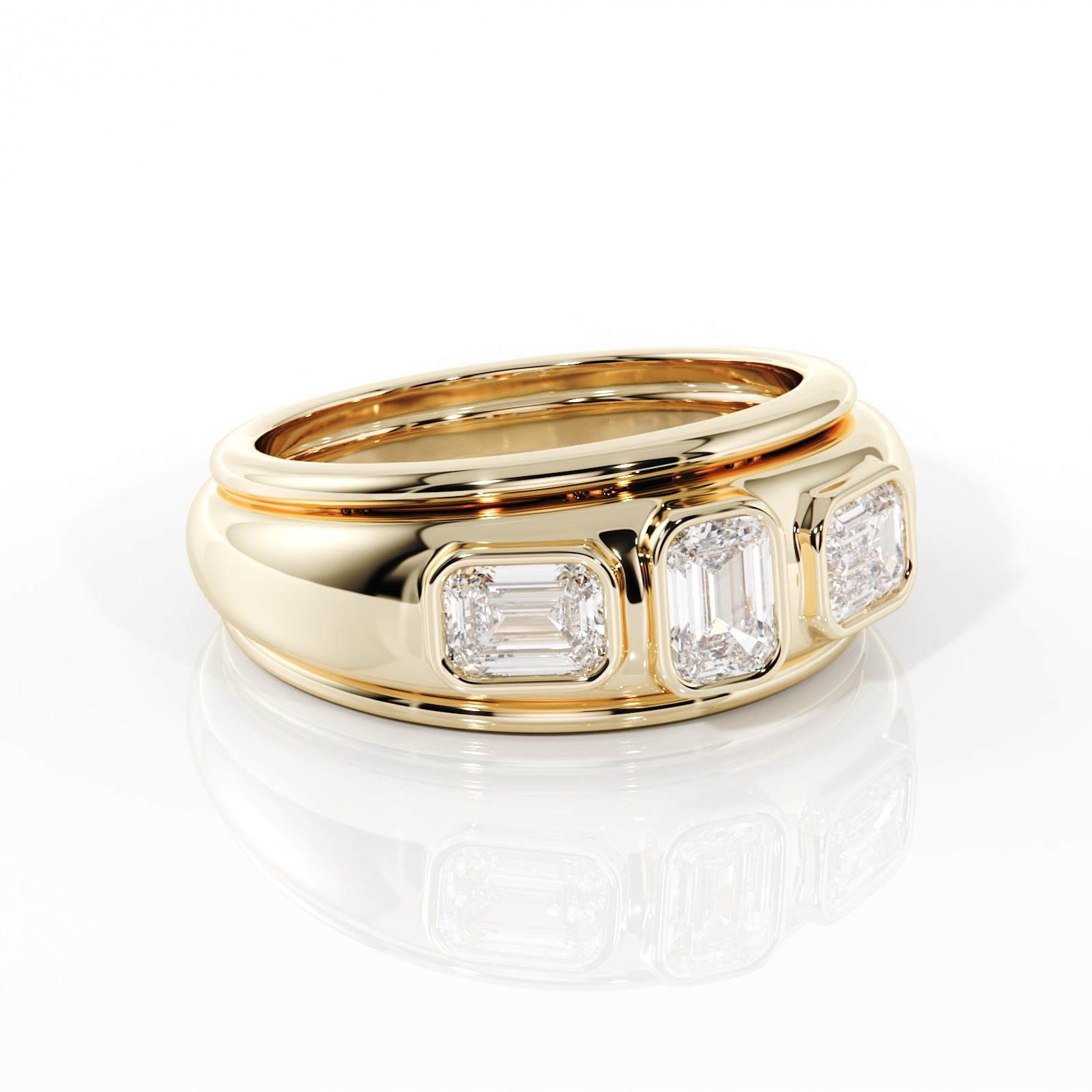 Gold ring with three emerald-cut diamonds on a white background