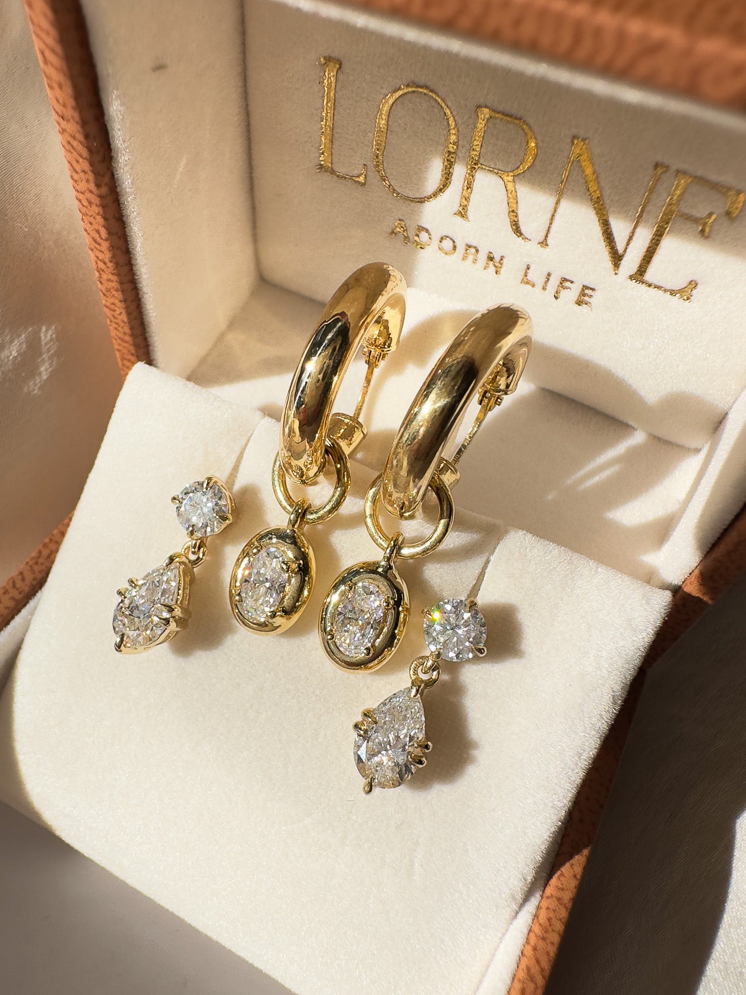 Gold earrings with diamonds in a LORNE box