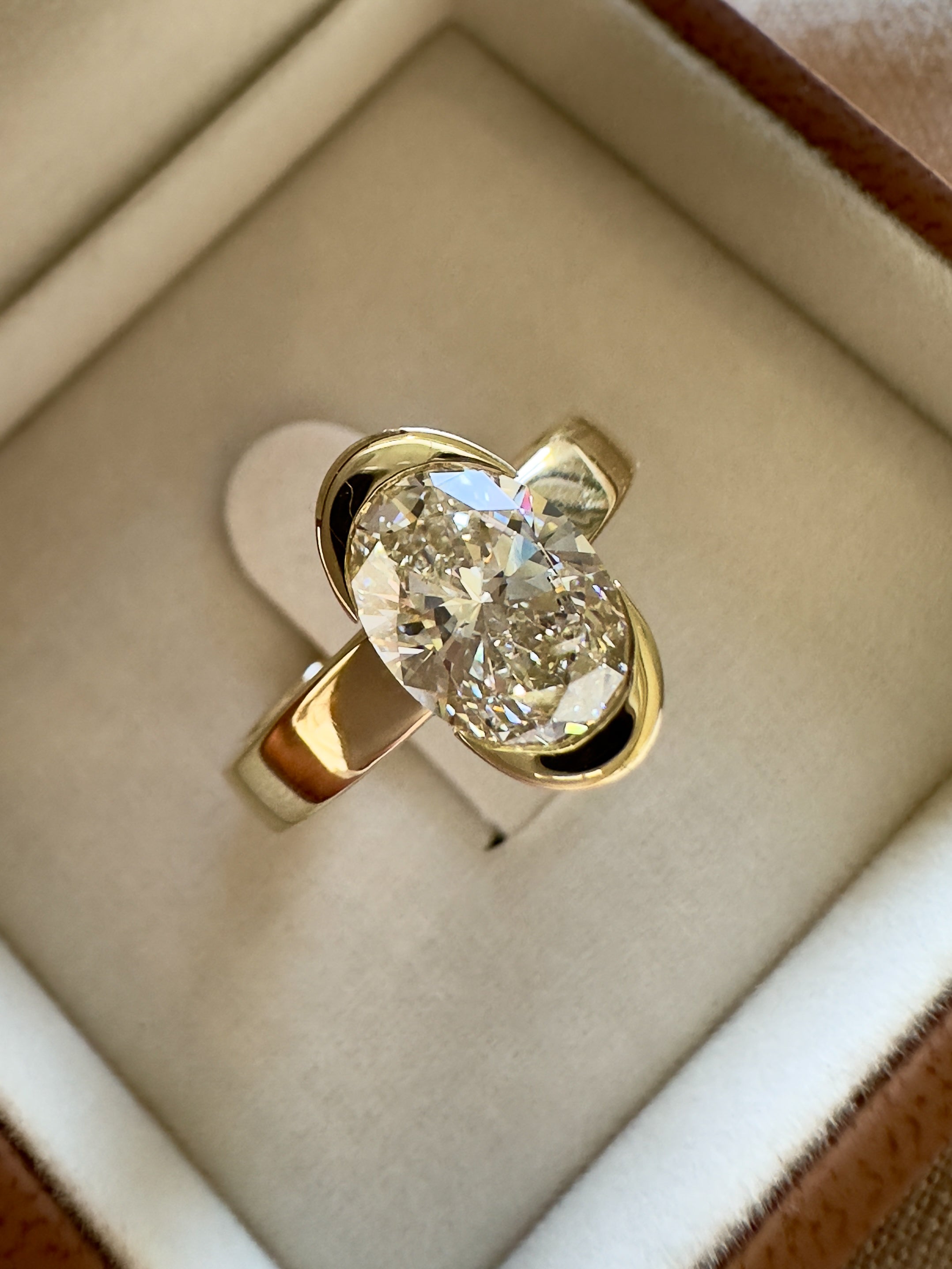 Gold ring with a large diamond in a jewelry box