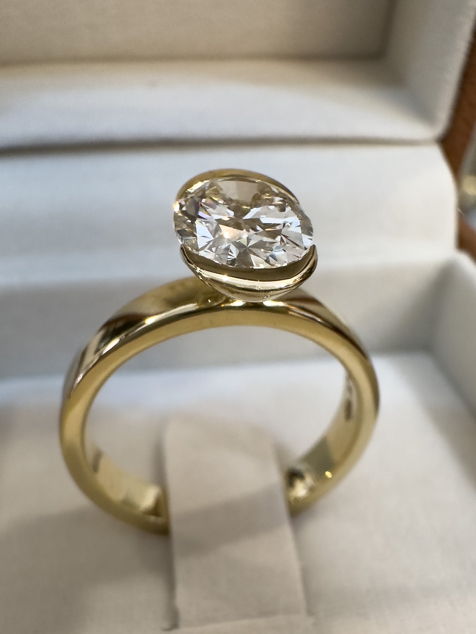 Gold ring with a large diamond in a box