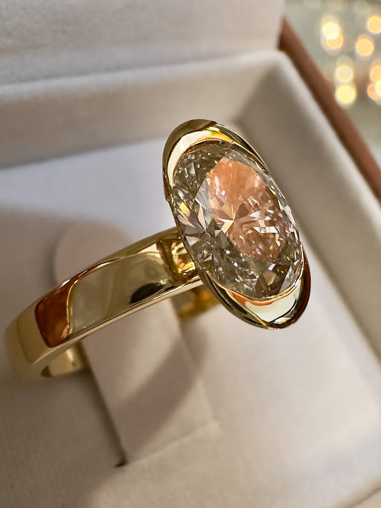Gold ring with a large diamond in a box