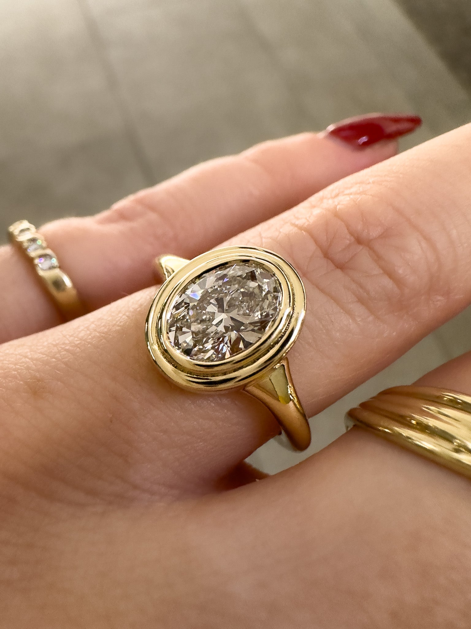 Gold ring with a large diamond on a hand