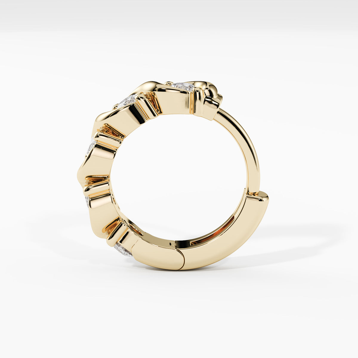 A gold huggie ring with a textured, segmented outer band and small clear gemstones set along the top, shown on a clean white background.