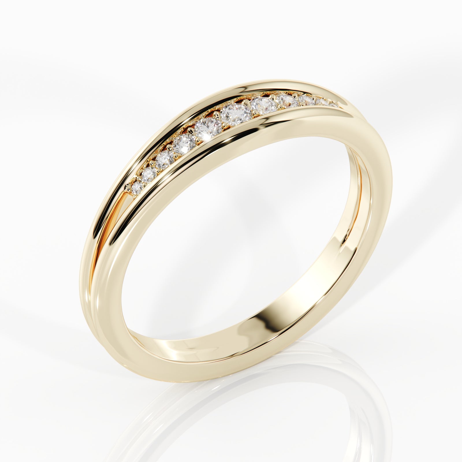 A polished yellow gold band ring featuring a curved channel set of small clear gemstones along the top, shown on a clean white background with a soft reflection below.